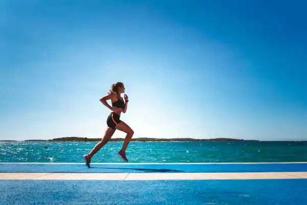 Woman running showing strong leg muscle Nottingham